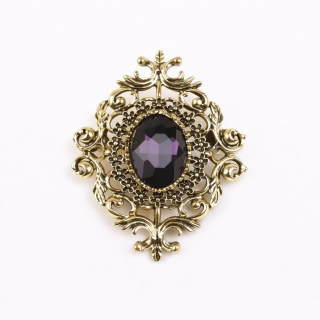 Broche doré avec fausse pierre violette